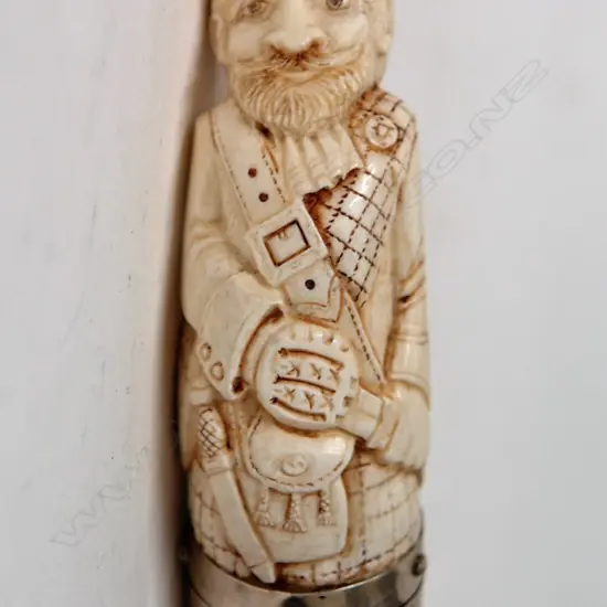 A sperm whale tooth carved snuff mull as a Scottish gent with silver fitting