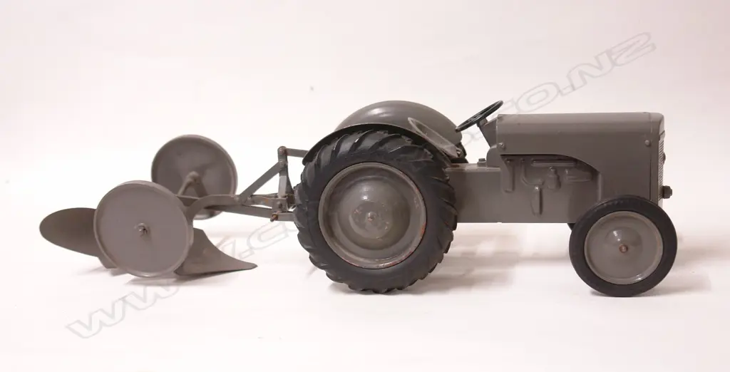 An old Massey Ferguson TE-20 die-cast toy tractor with plough Image 1++
