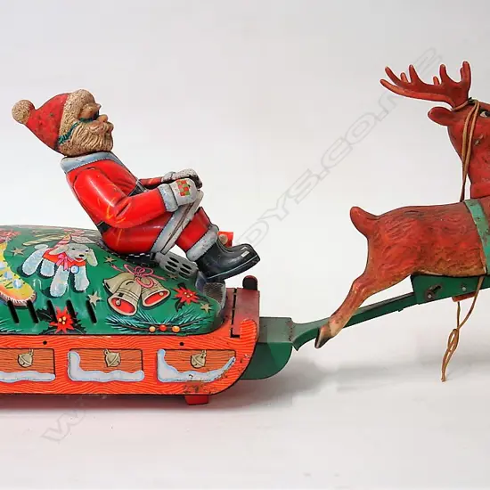 A vintage Japanese tin plate Santa on Sleigh battery toy
