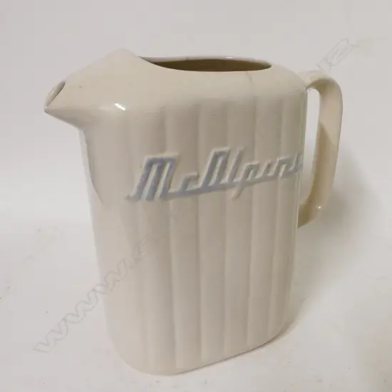 A vintage Crown Lynn green glazed McAlpine refrigerator jug