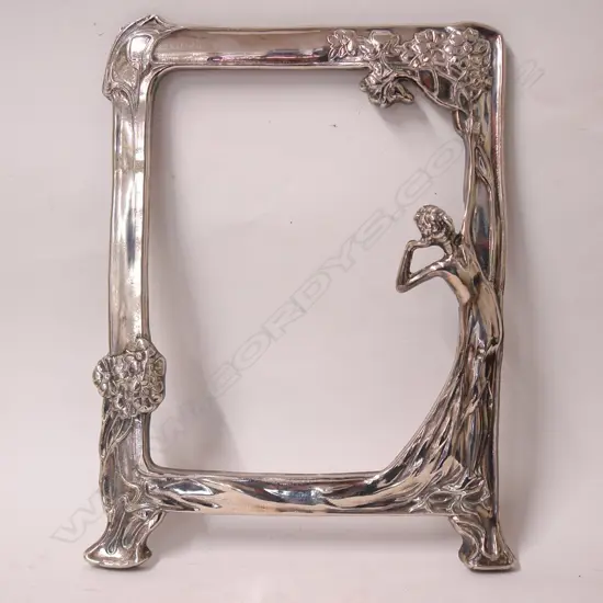 An Art Nouveau style silver plate mirror frame
