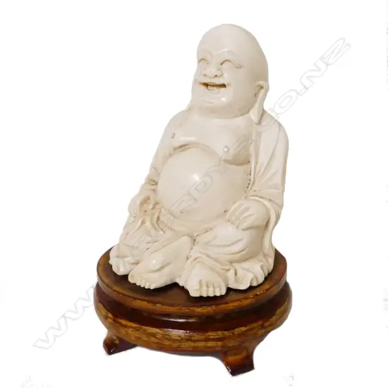 A solid Chinese ivory figure of the seated Hotei