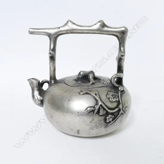 A Chinese white metal teapot