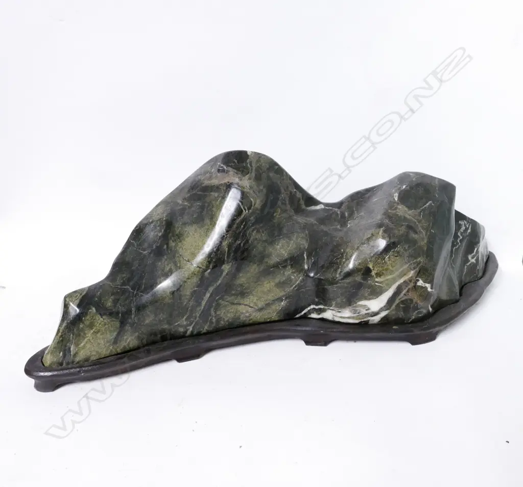 A large heavy variegated green stone mountainous boulder Image 1++