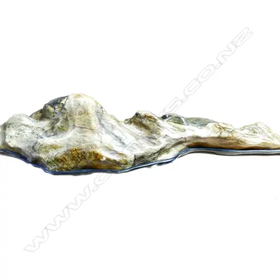 A large heavy variegated green and ochre hardstone mountainous boulder