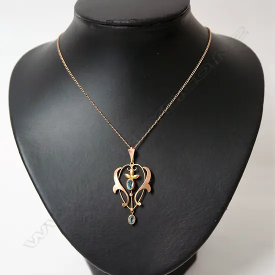 An Edwardian Art Nouveau 9ct. rose gold and blue topaz pendant