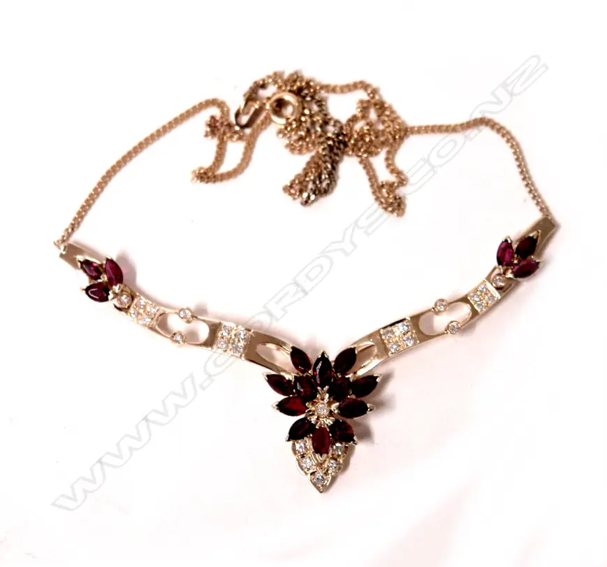 A 14ct. yellow gold ruby and diamond necklet on a 9ct. yellow gold chain Image 1++