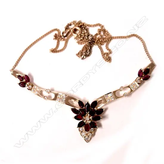 A 14ct. yellow gold ruby and diamond necklet on a 9ct. yellow gold chain