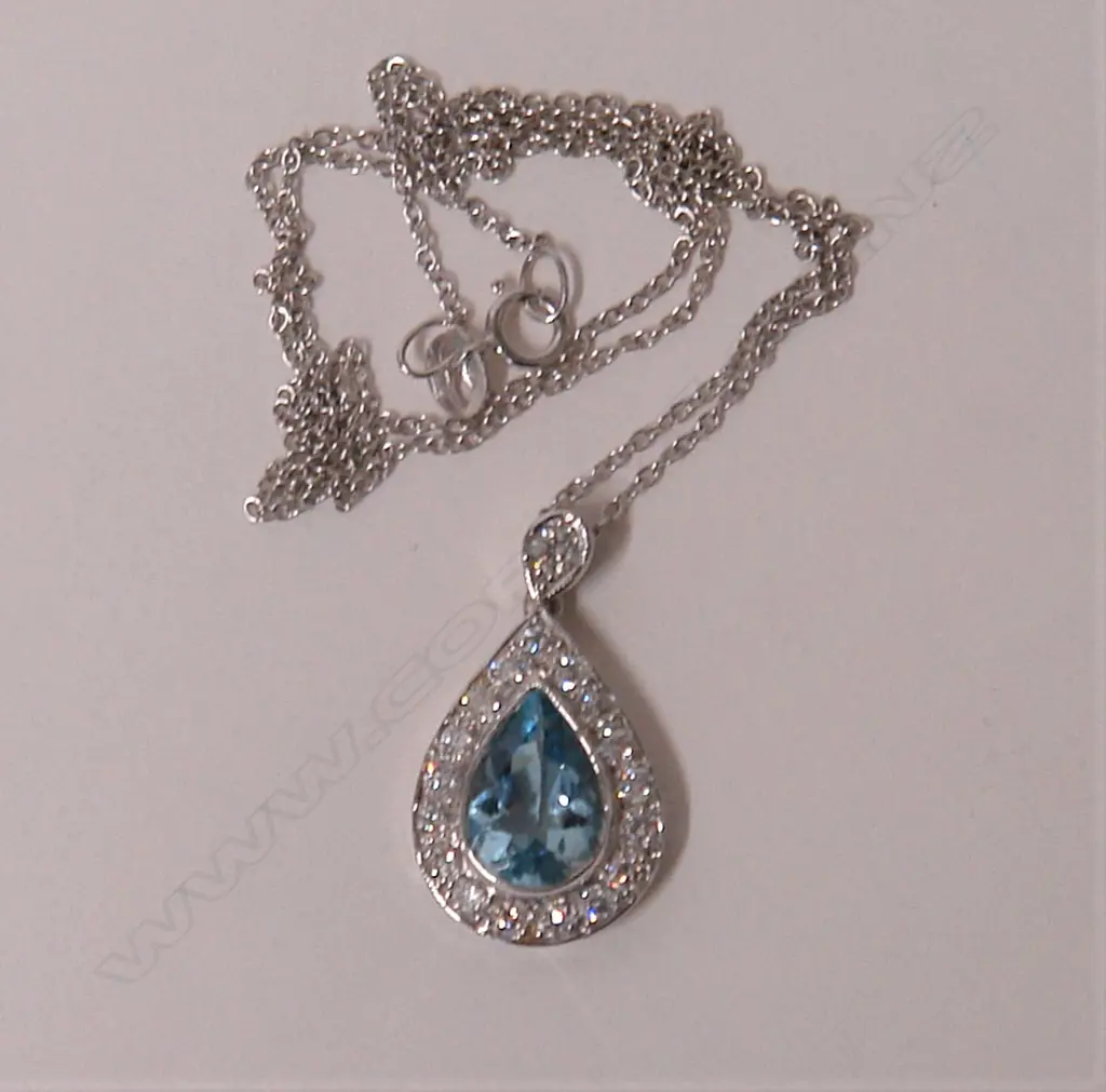 A lady's modern18ct. white gold aquamarine and diamond pendant on chain Image 1++