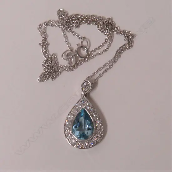A lady's modern18ct. white gold aquamarine and diamond pendant on chain