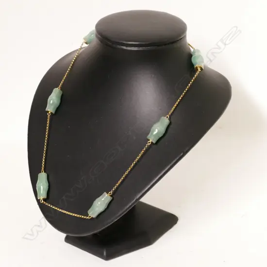 A jade bead and 14ct. yellow gold necklace