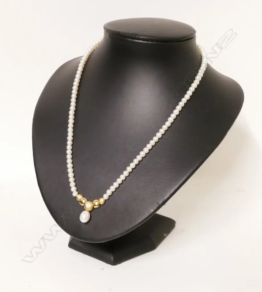 A cultured pearl necklace with 14ct. gold and diamond enhancer Image 1++