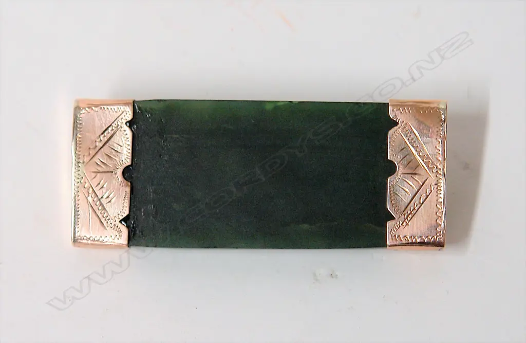 A 9ct. rose gold capped greenstone wide bar brooch Image 1++