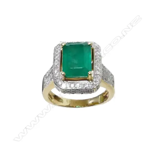 A 14ct. yellow emerald and diamond ring