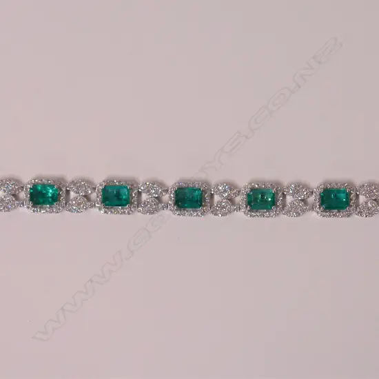 An impressive classical 18ct. white gold lady's modern emerald and diamond bracelet