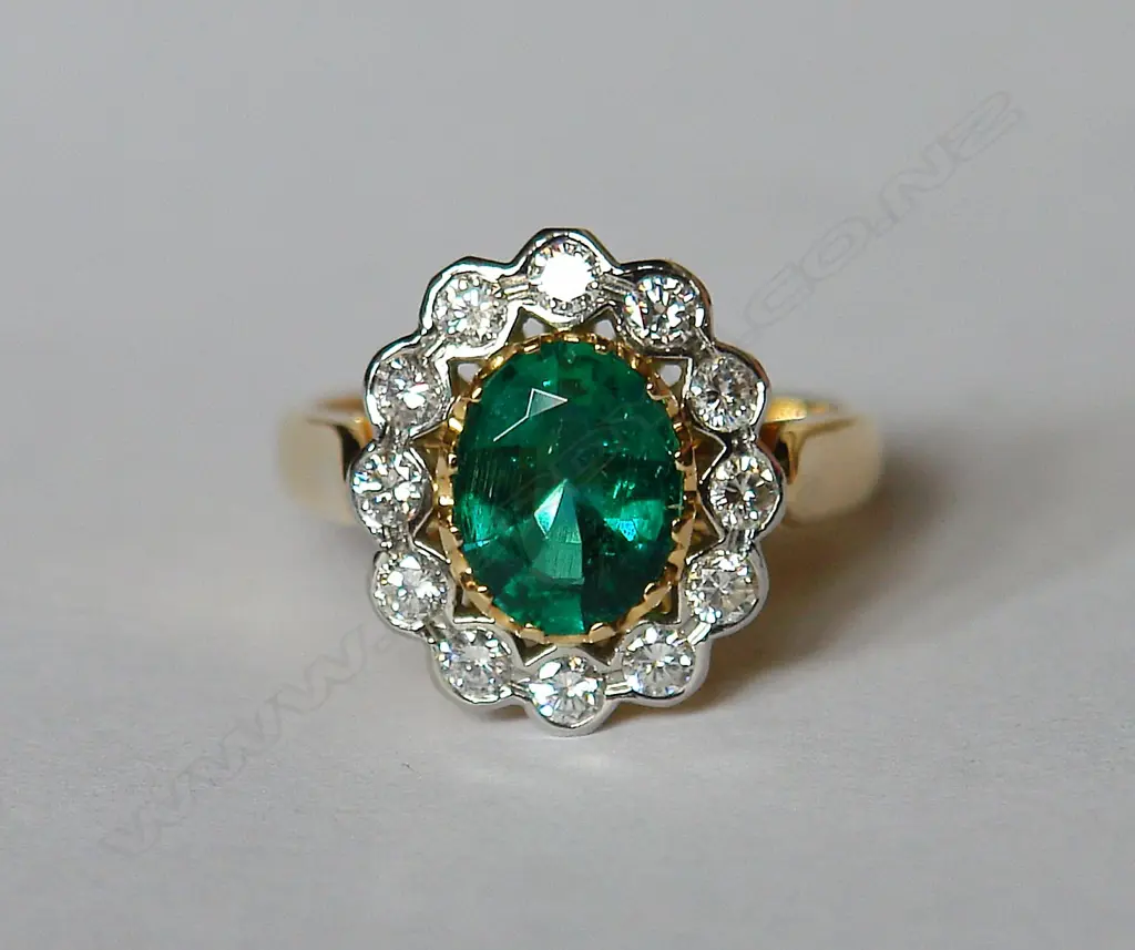 A lady's modern emerald and diamond cluster ring Image 1++