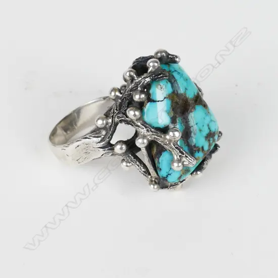 A unique vintage silver and turquoise matrix dress ring