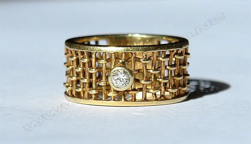 A 9ct. yellow gold wide basket weave solitaire diamond ring Image 1++