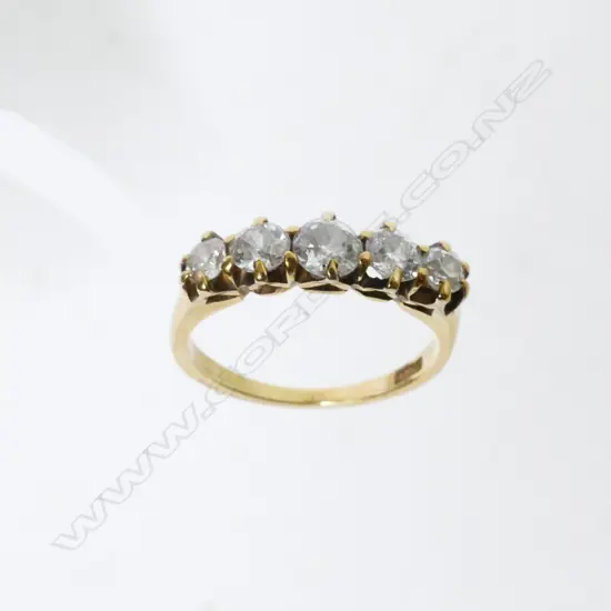 An estate 18ct. gold and five stone diamond ring