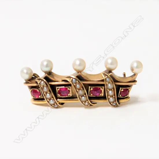 A 19thC 15ct. yellow gold ruby and seed pearl crown form brooch