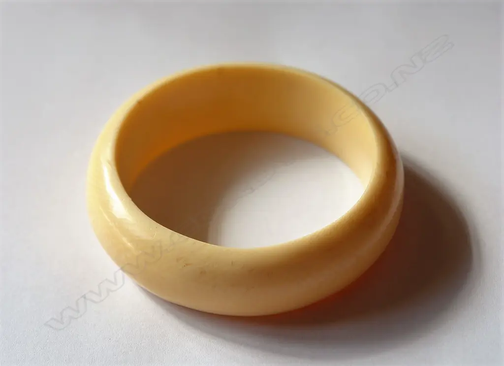 A substantial carved ivory bangle Image 1++