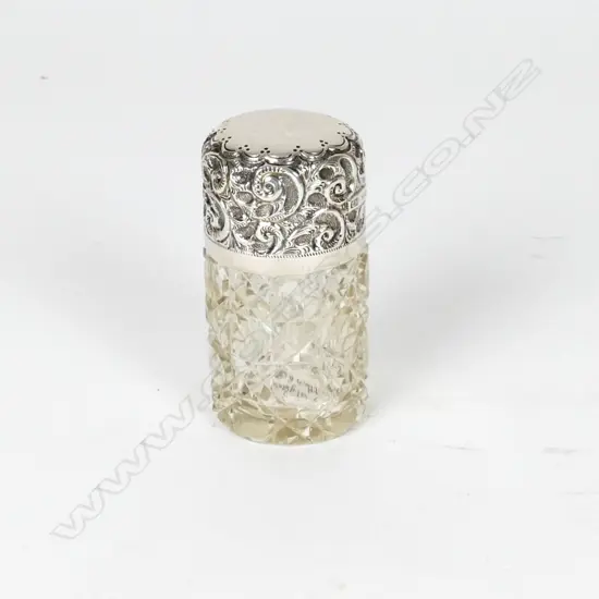An Edwardian silver topped glass perfume bottle