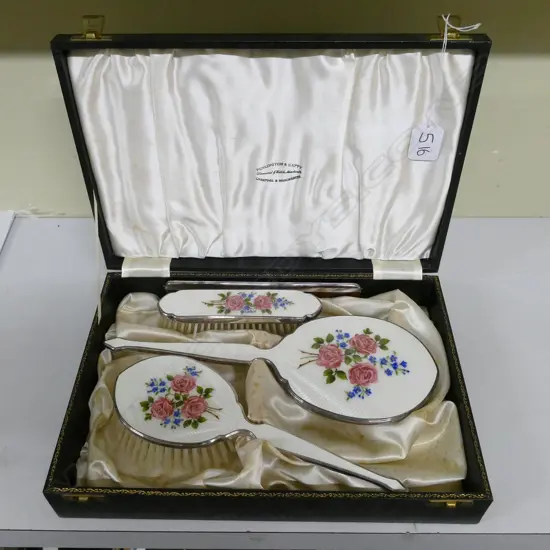 A three-piece silver dressing table set