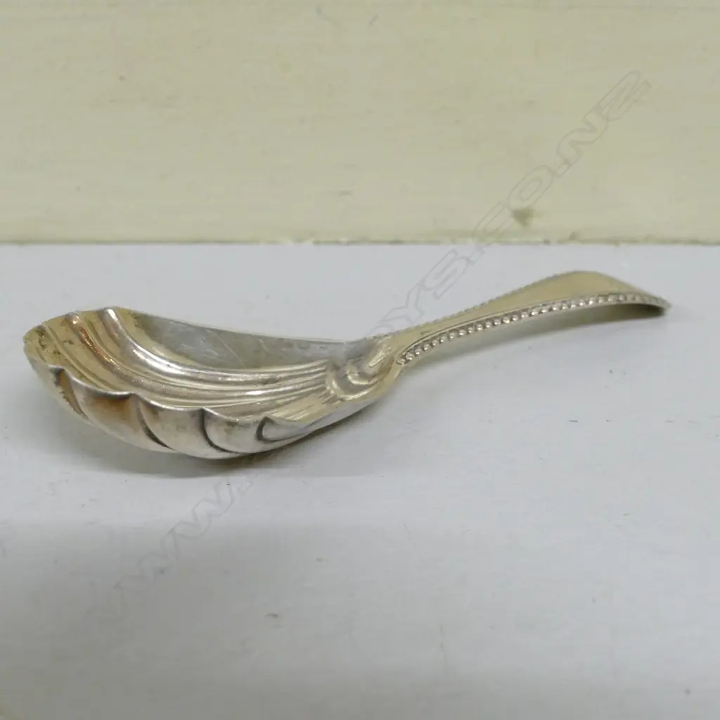 A George IV silver caddy spoon with shell bowl and a broad engraved handle Image 1++