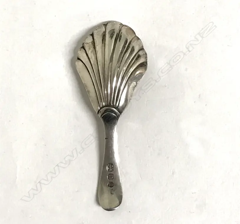 A George IV silver caddy spoon with shell bowl and a broad engraved handle Image 1++