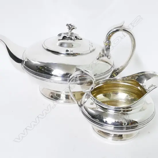 A William IV circular silver teapot and matching cream jug