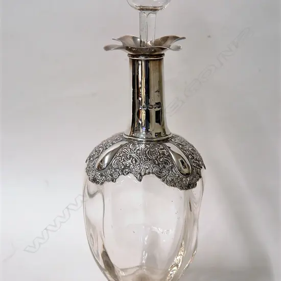 A late Victorian silver mounted dimpled glass decanter