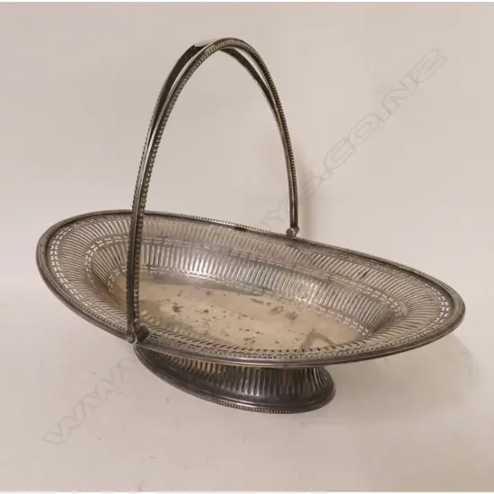 A heavy Georgian Revival silver cake basket