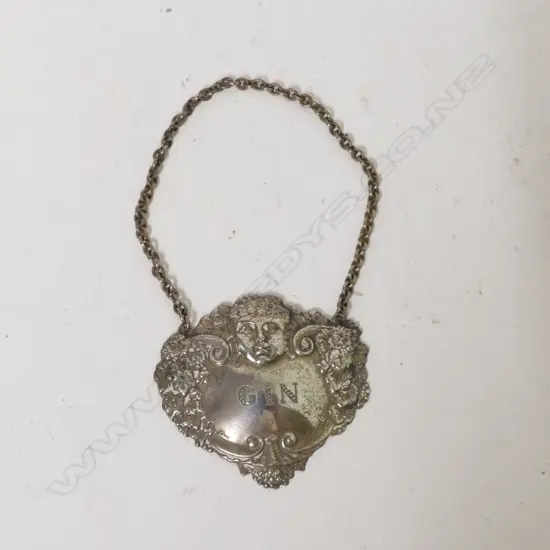 A silver 'Gin' bottle ticket
