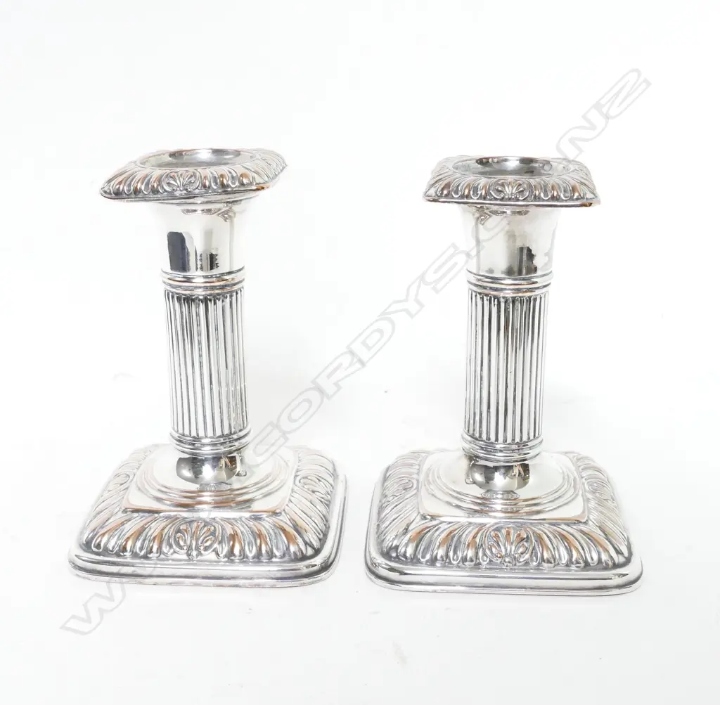 A pair of small Victorian silver plate on copper column candlesticks Image 1++