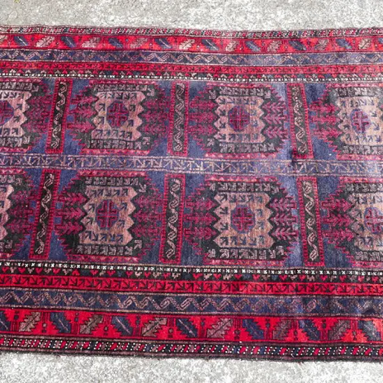 A hand knotted all wool Baluchi rug
