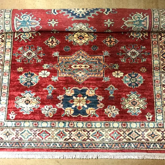 A hand knotted Kazak rug