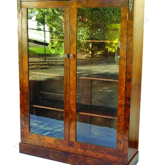 A walnut floor standing bookcase in the French manner