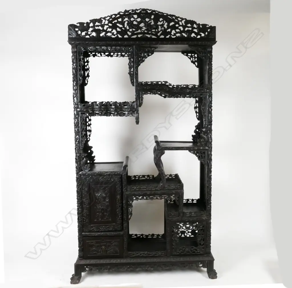 An ornate Chinese blackwood carved display cabinet Image 1++