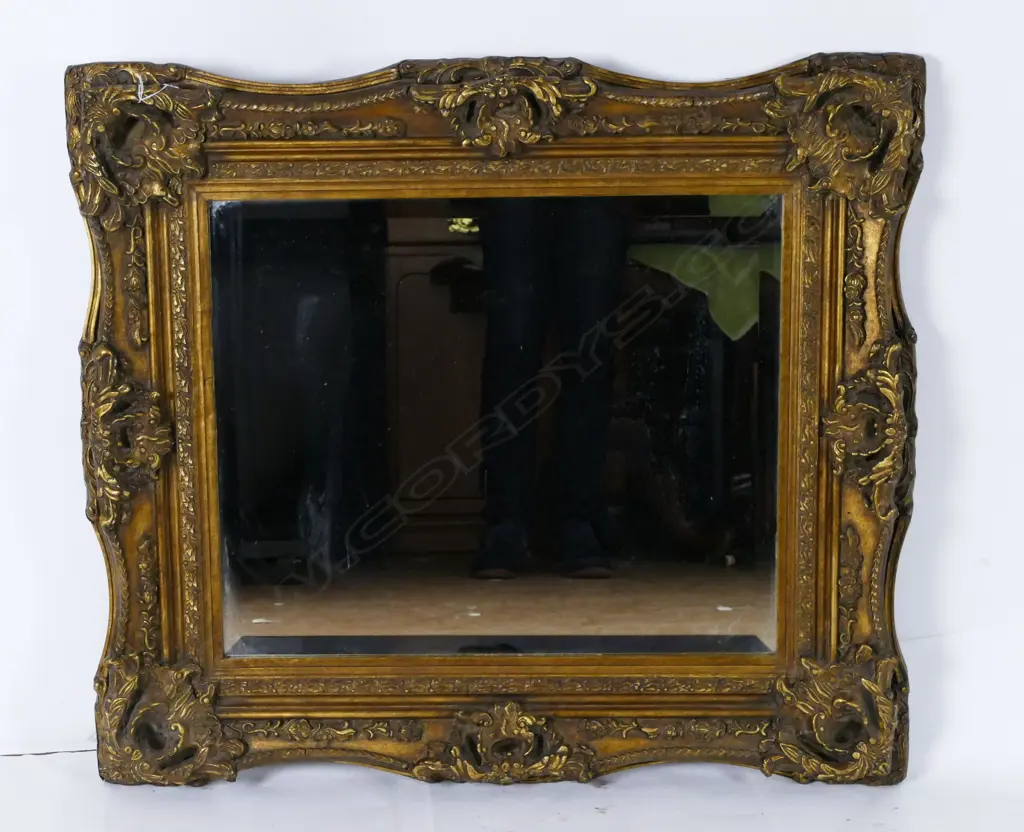 An ornate moulded gilt framed mirror Image 1++
