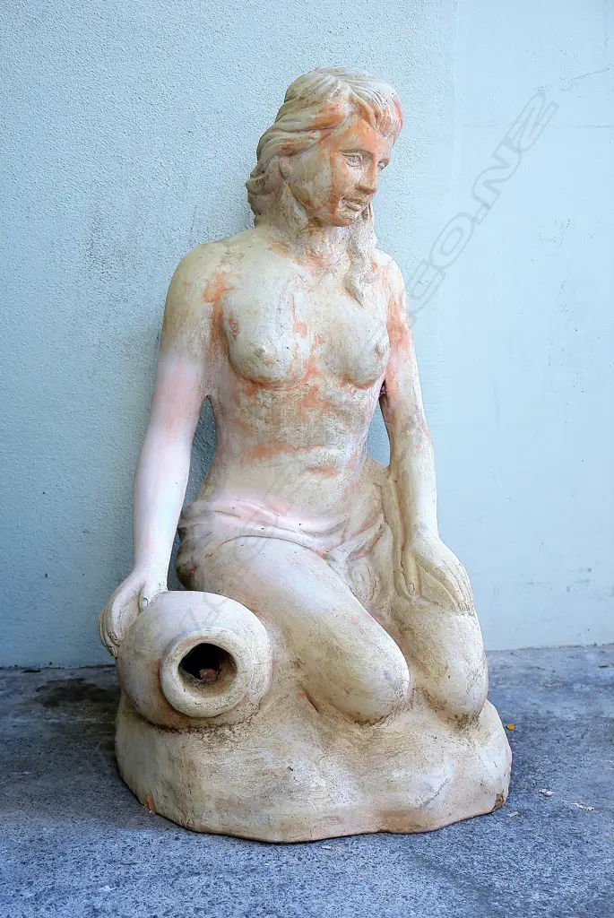 A large concrete garden sculpture of a semi-naked woman draped to her waist beside an urn Image 1++